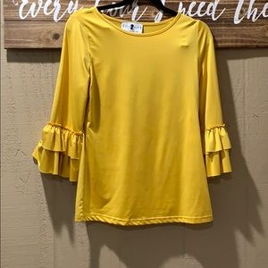 Danity Jewell’s layering ruffled shirt.